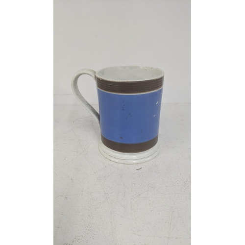 490 - A 19th century mocha ware mug with blue painted body and two ribbed borders
Location:4.1
If there is... 