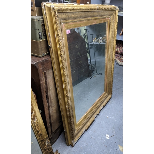 497 - A large gilt framed mirror with a beaded rim around the outer frame and a heavily decorated inside b... 