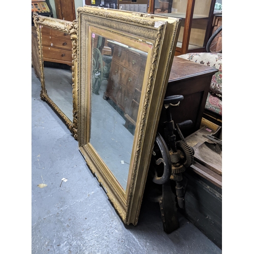 497 - A large gilt framed mirror with a beaded rim around the outer frame and a heavily decorated inside b... 