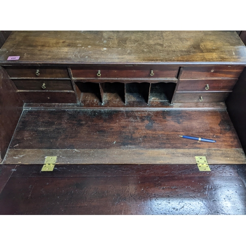 498 - An early 20th century mahogany bureau with a fall flap revealing an interior racking and drawers, wi... 