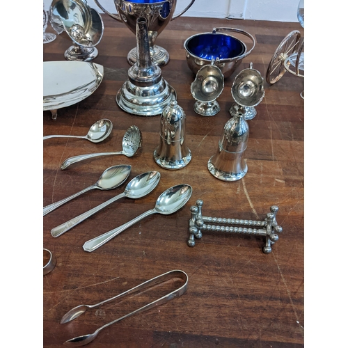 189 - A collection of silver plated items to include salt and pepper shakers, a twin handled sugar pot, fl... 