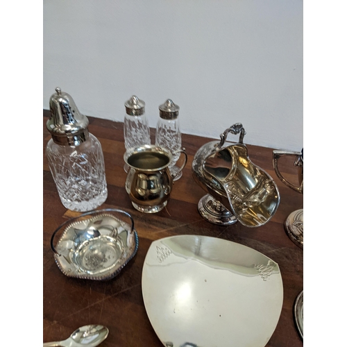 189 - A collection of silver plated items to include salt and pepper shakers, a twin handled sugar pot, fl... 