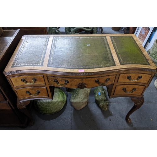 380 - An early 20th century walnut serpentine fronted writing desk with tooled green leather scriber inset... 