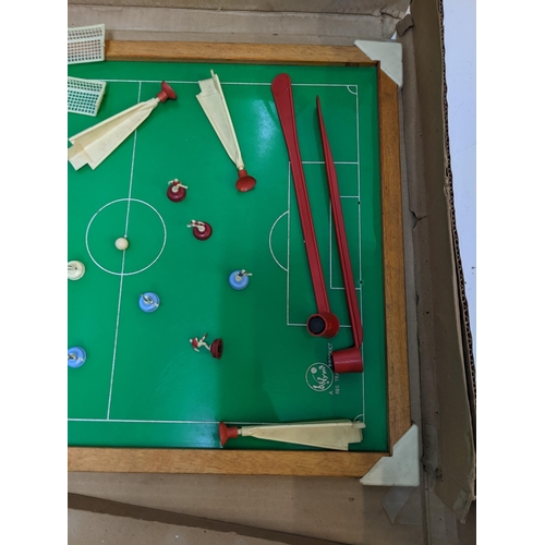 382 - A Super Soccer boardgame consisting of a table  magnetic rods and a quantity of red and blue players... 