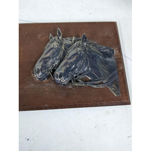 513 - Two similar silver plated plaques, each of two horse heads, on a wooden backing
Location:9.4
If ther... 