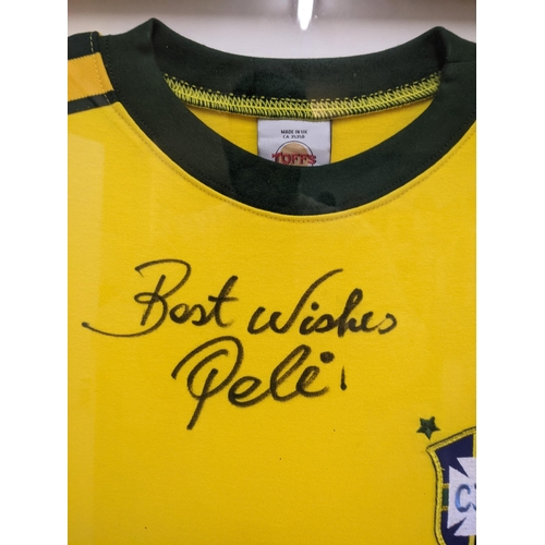 559 - A Brazilian football shirt and signed 'Best Wishes Pele' framed and glazed 81cm x 71cm Location: RWM... 