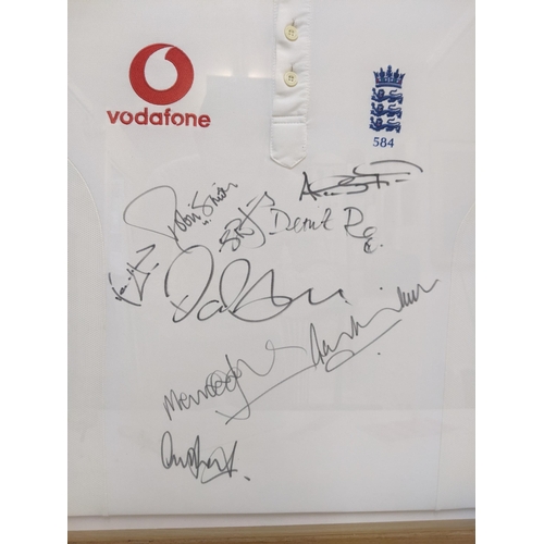 560 - An England cricket shirt bearing multiple signatures, framed and glazed, 81cm x 71cm Location: RAB
I... 