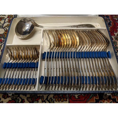 565 - A twelve-piece setting of French silver plated cutlery comprising tablespoons and forks, small servi... 