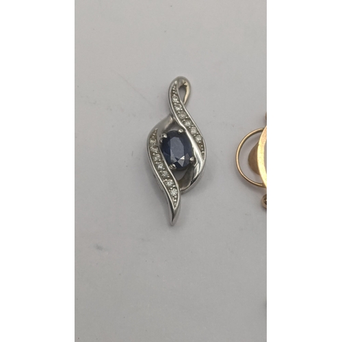 119 - A 10k white gold blue and white sapphire pendant 1.4g together with an Edwardian 9ct yellow gold rub... 