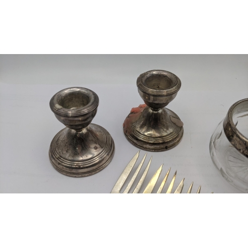 126 - A mixed lot of silver to include a pair of dwarf candle stick holders having weightless bases, a sil... 