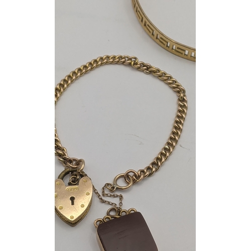 134 - A yellow metal curb link bracelet tested as 9ct gold, having a yellow metal front and back padlock c... 