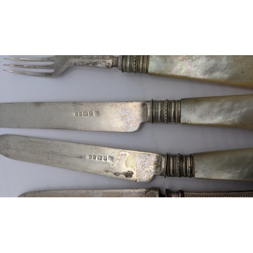 140 - A mixed cutlery to include two silver and mother of pearl forks and knives along with a set of four ... 