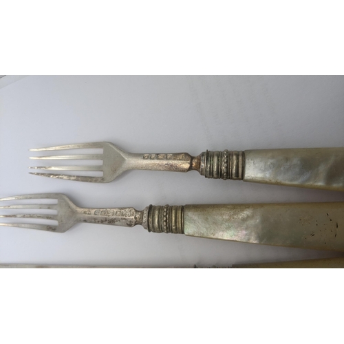 140 - A mixed cutlery to include two silver and mother of pearl forks and knives along with a set of four ... 