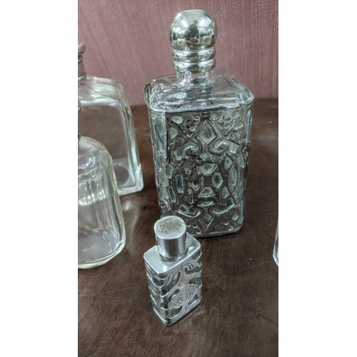 147 - A group of silver and white metal scent bottles to include a Victorian double-ended scent bottle wit... 