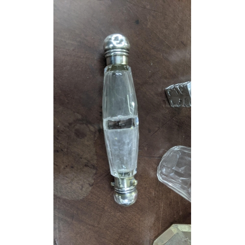 147 - A group of silver and white metal scent bottles to include a Victorian double-ended scent bottle wit... 