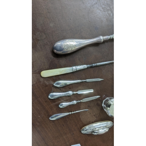 148 - A mixed lot to include silver handled manicure items to include nail files and a nail buffer A/F, si... 