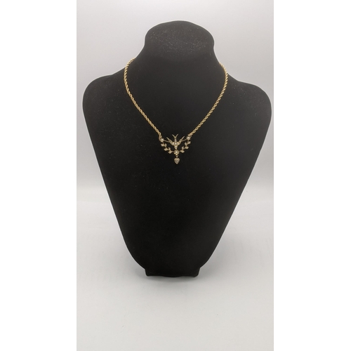 153 - A 9ct yellow gold and seed pearl swallow pendant, on a 9ct rope twist necklace, 5.3g
Location:CAB7
I... 