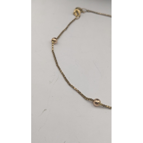 162 - Two ladies 9ct yellow gold necklaces to include an example with a floral pendant set with two sapphi... 