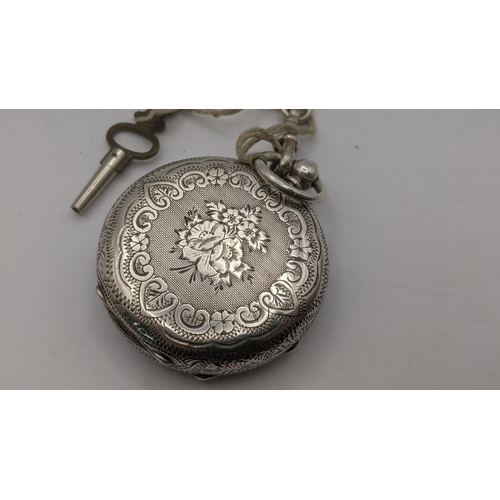 177 - A Victorian silver ladies open faced pocket watch having floral engraved decoration to the case, on ... 