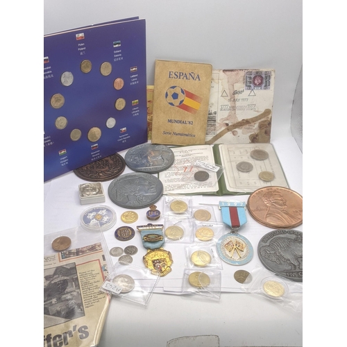 184 - A collection of coins from around the world to include commemorative examples, pre 1920's British si... 