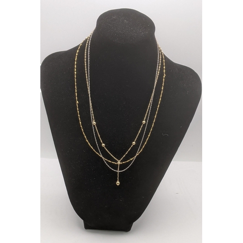 186 - A group of three gold fine chain necklaces to include a 14k gold chain, 2.4g, a 19k gold chain 1.3g ... 