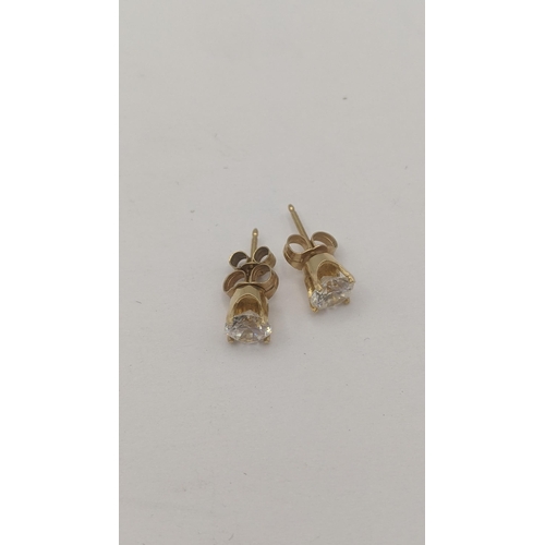 190 - A pair of 14ct yellow gold stud earrings set with brilliant cut paste stones, in four claw setting, ... 