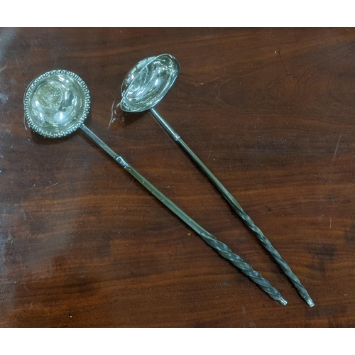 22 - Two white metal toddy ladles set with coins mounted to the bowls
Location:ST
If there is no conditio... 