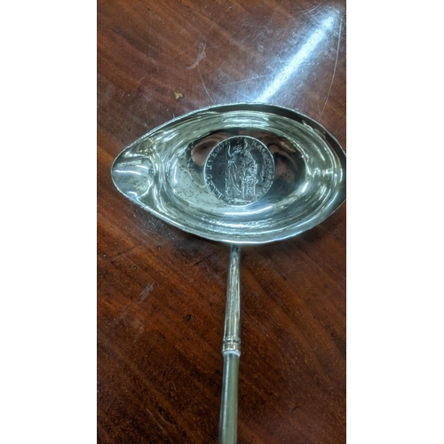 22 - Two white metal toddy ladles set with coins mounted to the bowls
Location:ST
If there is no conditio... 