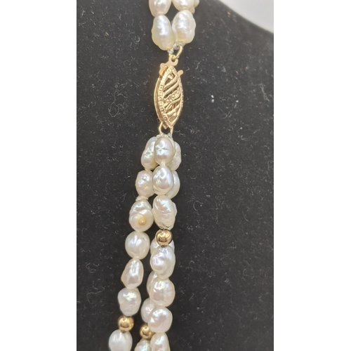 287 - A three strand pearl and gold ball strand necklace having a double 14ct yellow gold catch
Location: ... 