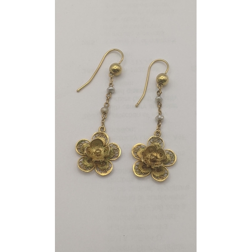 3 - A pair of yellow metal and pearl daisy earrings having a pierced design 4.6g tested as 9ct yellow go... 