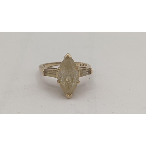 300 - A 14ct gold ring set with navette white stone, flanked by white stones to the shoulders, 4.2g
Locati... 