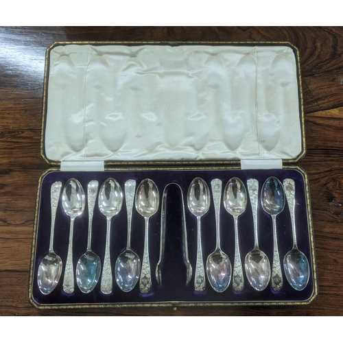 52 - A set of 12 Allen and Darwin silver teaspoons and a pair of sugar tongs having floral engraved termi... 