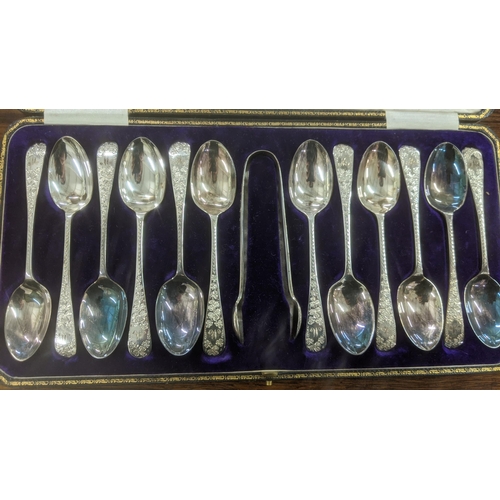 52 - A set of 12 Allen and Darwin silver teaspoons and a pair of sugar tongs having floral engraved termi... 