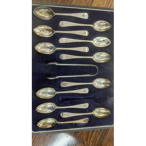 53 - A set of 11 Josiah Williams and Co silver teaspoons and sugar tongs housed in a fitted case (one spo... 