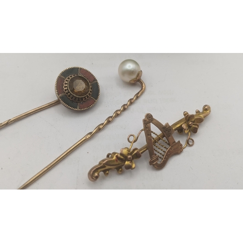 54 - Yellow gold to include: a 9ct and pearl stick pin, a yellow metal and enamel stick pin tested as 9ct... 