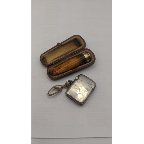 55 - Smoking related items to include a 9ct gold banded cheroot with its box along with a silver vesta ca... 