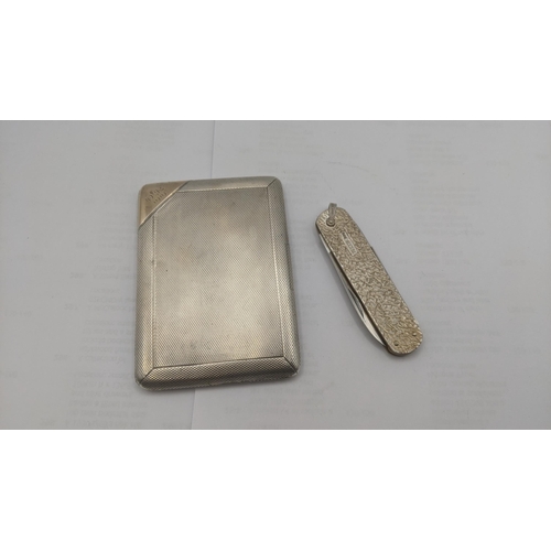 59 - An engine turned silver cigarette case having a guilt interior engraved 