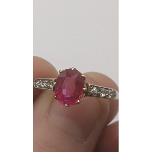 6 - 18ct yellow and white gold ring set with an oval cut ruby in a 8 claw setting flanked by three shoul... 