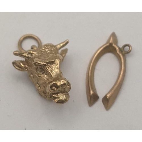 60 - Two 9ct yellow gold pendants to include a wishbone pendant and bull head pendant, total weight 2.5g
... 