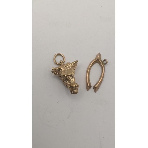 60 - Two 9ct yellow gold pendants to include a wishbone pendant and bull head pendant, total weight 2.5g
... 