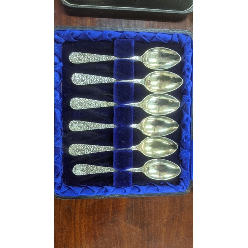 61 - Two sets of six silver teaspoons, one set having floral embossed handles, hallmarked Birmingham 1902... 