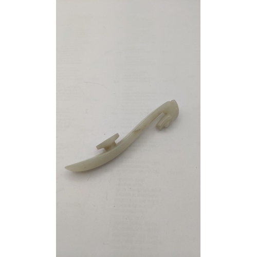 65 - A small Chinese carved white jade belt hook, with dragon head detail, 9 cm long, 22.6 grams
Location... 