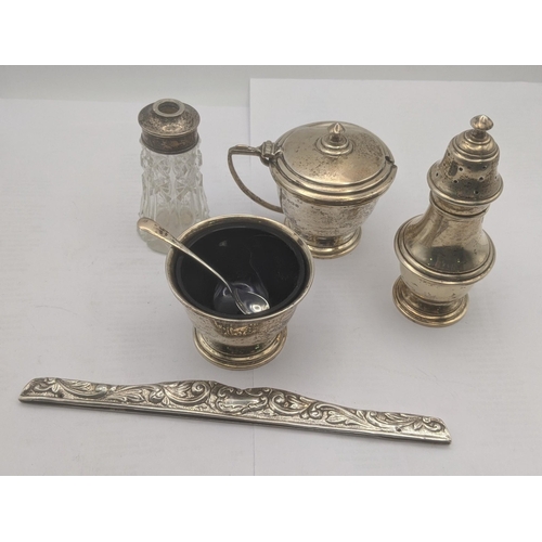 77 - Mixed silver items to include a three pieces cruet set with blue glass liners, a set of six knives i... 