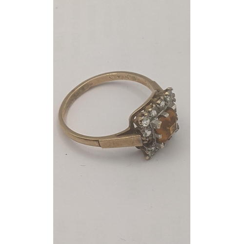 99 - A 9ct yellow gold ring set with a citrine coloured paste stone surrounded by paste stones A/F 2.4g
L... 