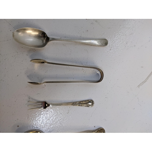 273 - A group of hallmarked silver flatware to include four teaspoons, a cake fork a pair of sugar tong, 1... 