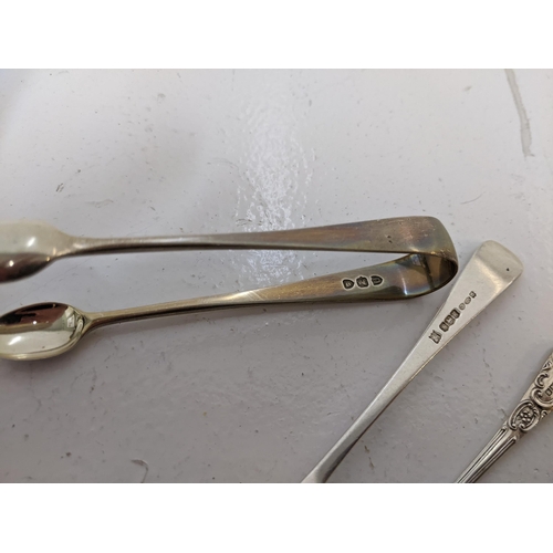 273 - A group of hallmarked silver flatware to include four teaspoons, a cake fork a pair of sugar tong, 1... 