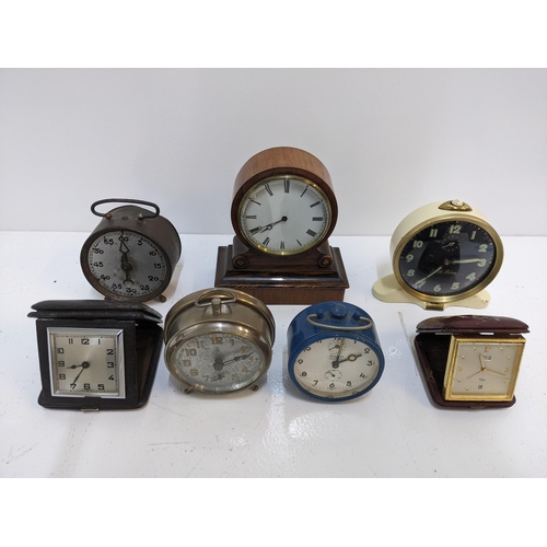 392 - A group of travel clocks and vintage alarm clocks to include a Smith alarm clock with Arabic dial, a... 