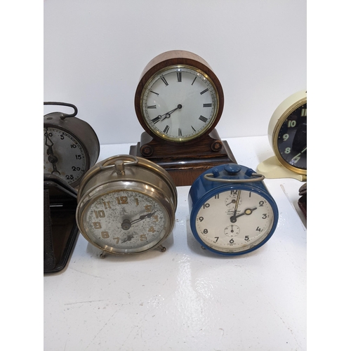 392 - A group of travel clocks and vintage alarm clocks to include a Smith alarm clock with Arabic dial, a... 