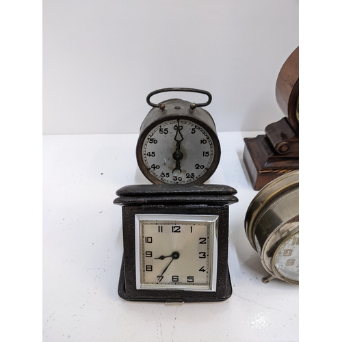 392 - A group of travel clocks and vintage alarm clocks to include a Smith alarm clock with Arabic dial, a... 