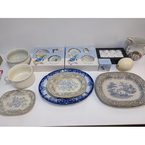 413 - A mixed lot of ceramics to include two boxed Wedgwood Peter Rabbit sets, a boxed mug, two chamber po... 